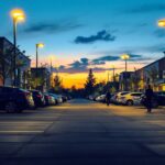 A photograph of a well-lit commercial parking lot at dusk