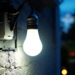 A photograph of a solar light bulb with an attached solar panel installed in a well-lit outdoor setting