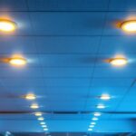 A photograph of a well-lit drop ceiling installation featuring recessed lights