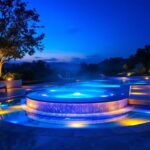 A photograph of a beautifully illuminated pool spa at dusk