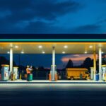 A photograph of a well-lit gas station at dusk