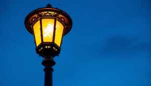 A photograph of a beautifully illuminated lamp post at dusk