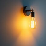 A photograph of a beautifully designed wall sconce illuminated with warm