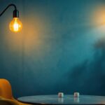 A photograph of a modern lamp design illuminated in a stylish interior setting