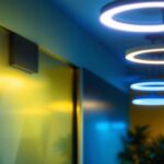 A photograph of a modern interior space featuring sleek fluorescent round light fixtures