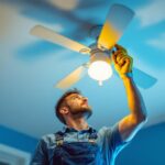 A photograph of a skilled lighting contractor installing a ceiling fan
