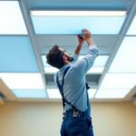 A photograph of a modern ceiling installation featuring led light panels in a well-lit room
