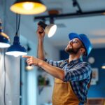 A photograph of a lighting contractor in action