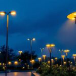 A photograph of a well-lit outdoor space showcasing various tall lighting fixtures in use