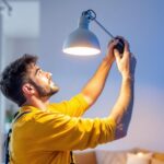 A photograph of a skilled lighting contractor expertly installing or adjusting the mr 16 lamp in a stylish residential or commercial setting