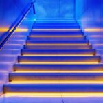 A photograph of a beautifully designed indoor staircase featuring stylish tread lights that illuminate the steps