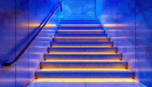 A photograph of a beautifully designed indoor staircase featuring stylish tread lights that illuminate the steps
