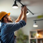 A photograph of a lighting contractor expertly installing or adjusting lighting fixtures in a well-lit commercial or residential space