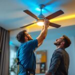 A photograph of a skilled lighting contractor installing a stylish light kit on a ceiling fan in a modern living space
