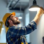 A photograph of a lighting contractor in action