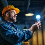 A photograph of a lighting contractor installing the sylvania fo32/841/eco bulb in a commercial setting