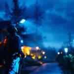 A photograph of a professional lighting contractor installing solar led flood lights in an outdoor setting