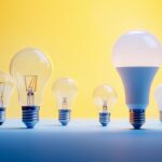 A photograph of a variety of light bulb bases displayed alongside their corresponding light bulbs