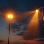 A photograph of a beautifully illuminated flagpole at dusk