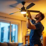 A photograph of a skilled lighting contractor installing a stylish ceiling fan in a beautifully designed living room