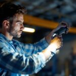 A photograph of a lighting contractor adjusting a sleek
