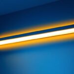 A photograph of a sleek and modern decorative fluorescent light fixture installed in a stylish interior setting