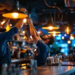 A photograph of a lighting contractor installing overhead bar lights in a vibrant bar setting