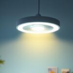 A photograph of a stylish light fixture with an integrated fan