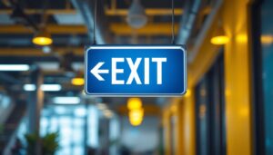 A photograph of a well-lit exit sign made of metal