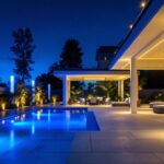 A photograph of a beautifully illuminated outdoor space showcasing intricate lighting designs