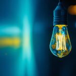 A photograph of a close-up of a flickering fluorescent light bulb in a dimly lit room