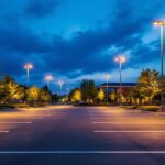 A photograph of a beautifully illuminated parking lot at dusk