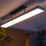 A photograph of a stylish ceiling bar light fixture installed in a modern living space