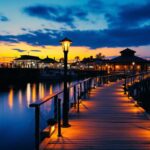 A photograph of a well-lit dock at twilight