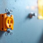 A photograph of a close-up shot of an orange electrical receptacle installed in a modern setting