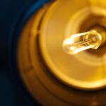 A photograph of a close-up view of a mogul light bulb base installed in a lighting fixture