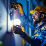A photograph of a lighting contractor inspecting or installing led lamps in a residential or commercial setting