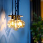 A photograph of a stylish 6 bulb light fixture installed in a modern interior setting