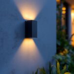 A photograph of a beautifully designed outdoor led sconce light installed on a modern exterior wall