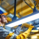 A photograph of a lighting contractor installing a sleek