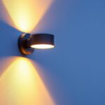 A photograph of a beautifully designed up-down outdoor wall light installed on a stylish exterior wall