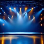A photograph of a well-lit theater stage showcasing various lighting fixtures in use