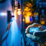 A photograph of a lighting contractor working with a 12-volt transformer