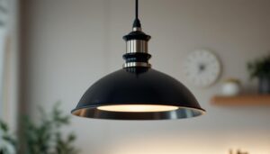 A photograph of a stylish black and brushed nickel pendant light hanging in a modern kitchen or dining space