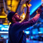 A photograph of a lighting contractor installing or adjusting modern bar lights in a stylish bar or restaurant setting