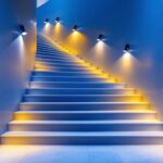 A photograph of a beautifully lit staircase that showcases a variety of lighting techniques