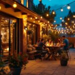 A photograph of a well-lit outdoor patio scene adorned with decorative lights